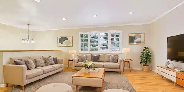 Image 4: (Virtually Staged) Living Room - Spacious living room filled with natural light, featuring beautifully refinished hardwood floors, recessed lighting, and plantation shutters for timeless style. Image 4: (Virtually Staged) Living Room - Spacious living room filled with natural light, featuring beautifully refinished hardwood floors, recessed lighting, and plantation shutters for timeless style.