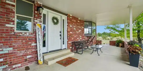 Image 2: Covered front porch welcomes you and guests!