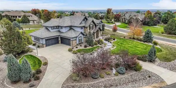 Image 3: Oversized 4-car garage offering ample space for vehicles, storage, and hobbies. Just off the wide driveway, a built-in basketball hoop is perfect for casual games or practicing your shot at home.