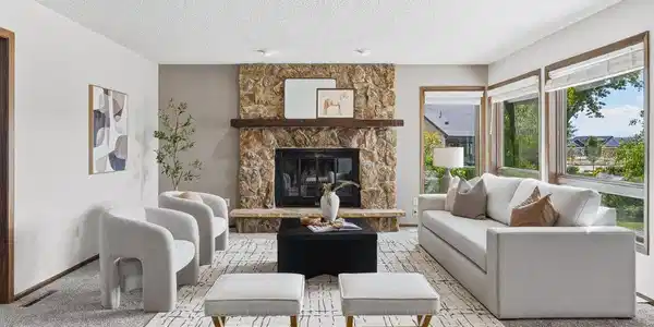 Image 4: Light-filled living room anchored by a beautiful stone fireplace. Image 4: Light-filled living room anchored by a beautiful stone fireplace.