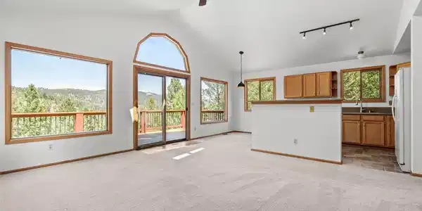 Image 4: Vaulted ceilings and expansive windows frame breathtaking mountain views. Image 4: Vaulted ceilings and expansive windows frame breathtaking mountain views.