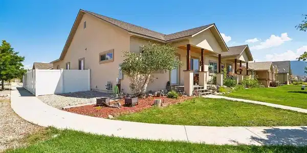 Image 3: Corner lot - vinyl fencing with room for additional off street parking or a private side yard space.
