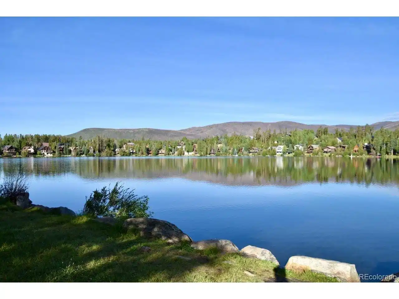 Image 1: View from across Columbine Lake looking toward the home Image 1: View from across Columbine Lake looking toward the home