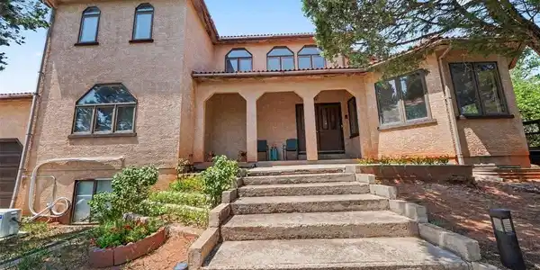 Image 3: A set of steps leads to the home, surrounded by established landscaping and mature trees that provide privacy and a peaceful, secluded feel Image 3: A set of steps leads to the home, surrounded by established landscaping and mature trees that provide privacy and a peaceful, secluded feel