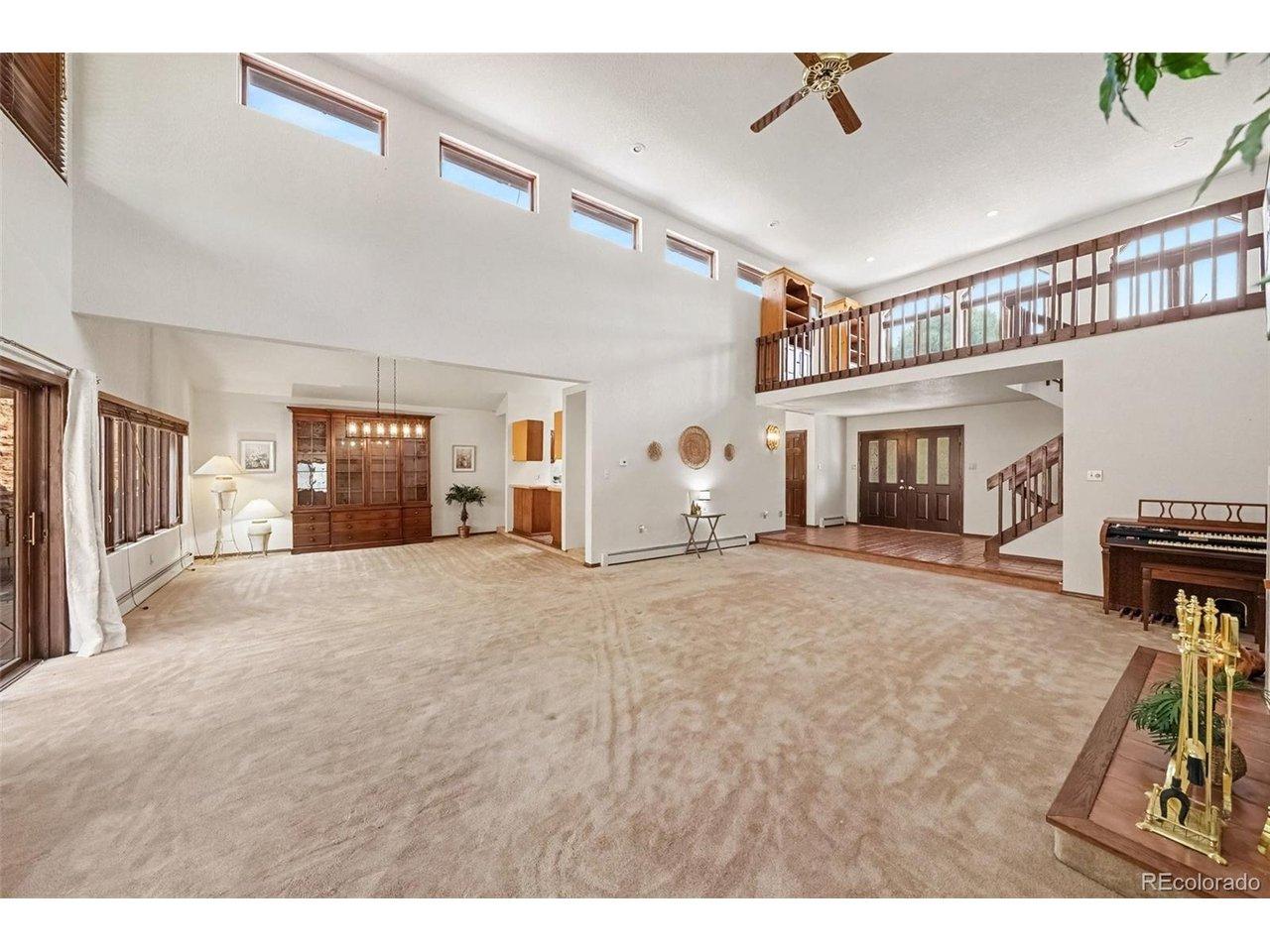 Image 4: Spacious living room featuring soaring ceilings, two ceiling fans, and a cozy fireplace Image 4: Spacious living room featuring soaring ceilings, two ceiling fans, and a cozy fireplace