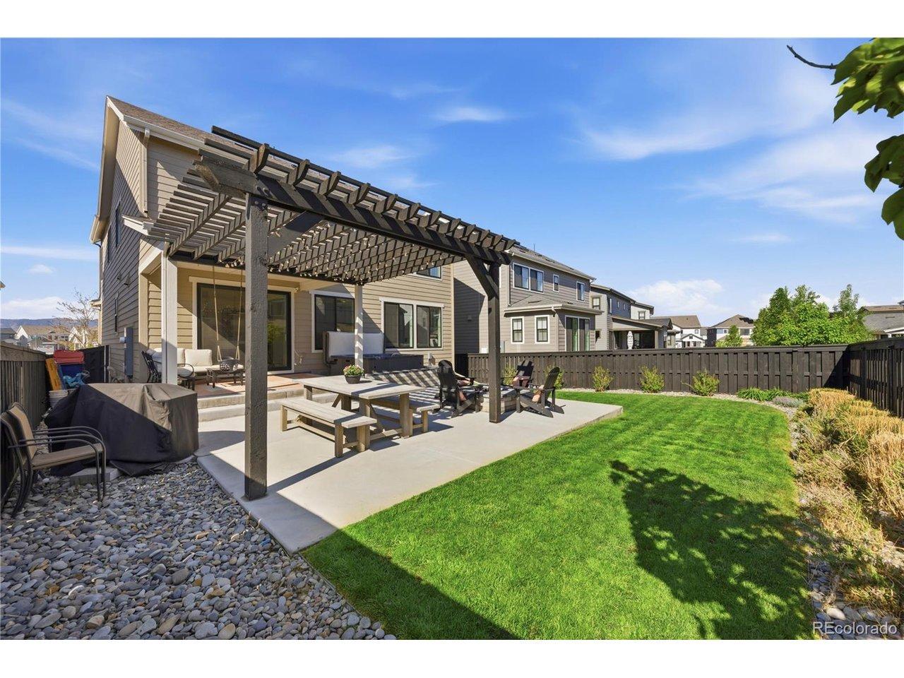 Image 4: Fully fenced yard provides privacy, and strikes a balance between green grass and lower-water plants and landscaping. Image 4: Fully fenced yard provides privacy, and strikes a balance between green grass and lower-water plants and landscaping.
