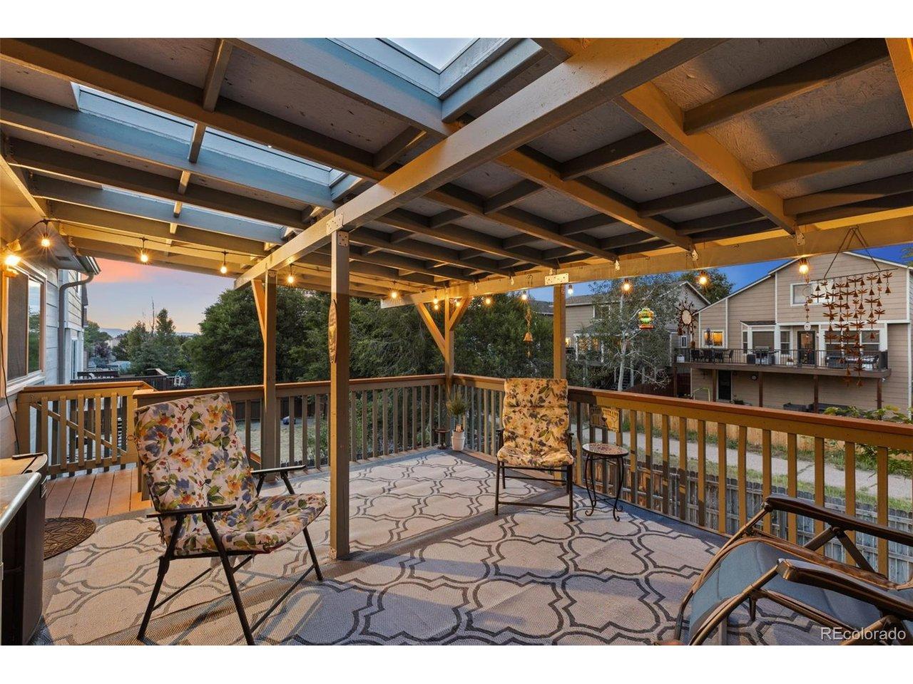 Image 4: The covered deck is perfect for entertaining or relaxing outdoors, with stellar sunset views Image 4: The covered deck is perfect for entertaining or relaxing outdoors, with stellar sunset views
