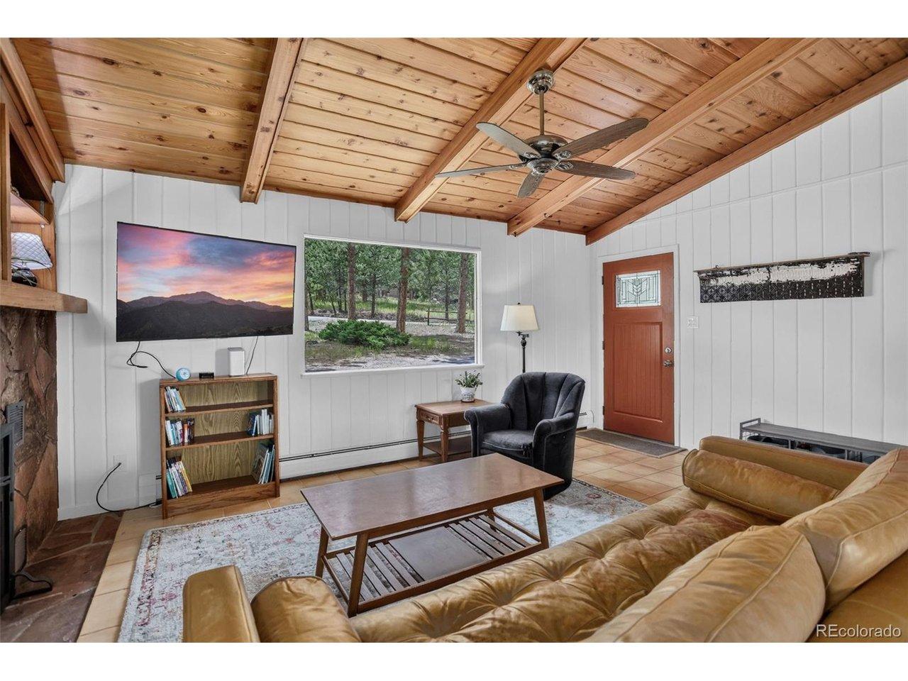 Image 2: Spacious Living Room with Vaulted Ceilings