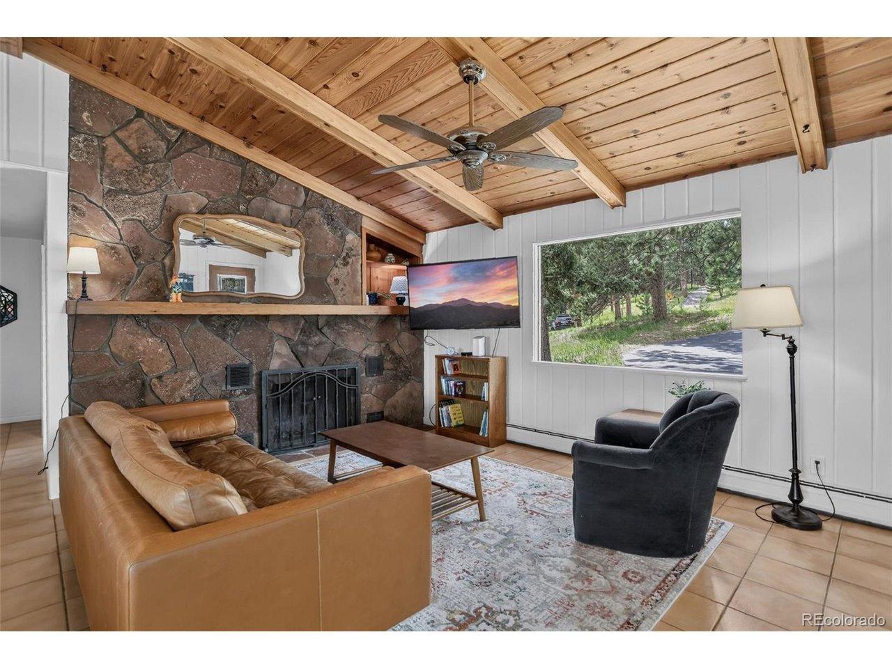 Image 3: Living Room with Wood Burning Fireplace and Built-in Cabinet
