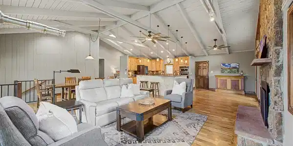 Image 2: Great Room with solid wood floors, vaulted ceilings, and open to kitchen and dining. Image 2: Great Room with solid wood floors, vaulted ceilings, and open to kitchen and dining.