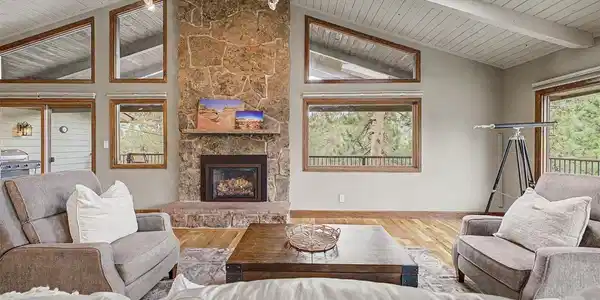 Image 3: Gorgeous stone gas fireplace flanked with windows. Image 3: Gorgeous stone gas fireplace flanked with windows.