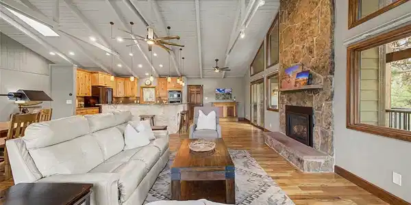 Image 4: Great Room with solid wood floors, vaulted ceilings, and open to kitchen and dining. Image 4: Great Room with solid wood floors, vaulted ceilings, and open to kitchen and dining.