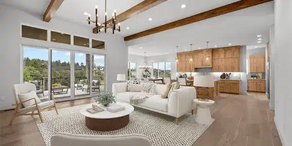 Image 2: Virtually staged to inspire - the great room flows seamlessly into the kitchen and dining areas, with vaulted ceilings, exposed beams, and walls of windows that frame the deck and treetop views. Image 2: Virtually staged to inspire - the great room flows seamlessly into the kitchen and dining areas, with vaulted ceilings, exposed beams, and walls of windows that frame the deck and treetop views.