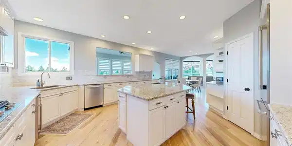 Image 3: The kitchen is expansive and features stainless appliances, center island, lots of counterspace and cabinetry, and wonderful views while doing dishes! Image 3: The kitchen is expansive and features stainless appliances, center island, lots of counterspace and cabinetry, and wonderful views while doing dishes!