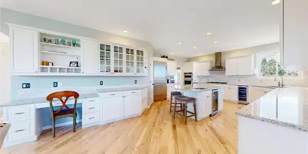 Image 4: The kitchen has a built-in desk, built in shelving, and some glass fronted cabinets. Image 4: The kitchen has a built-in desk, built in shelving, and some glass fronted cabinets.