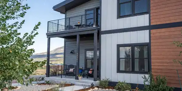 Image 4: Front porch and upper primary suite balcony