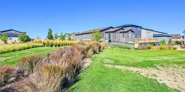Image 2: Situated on a premium lot with open space behind and to the west, this property offers unmatched privacy and  mountain views.