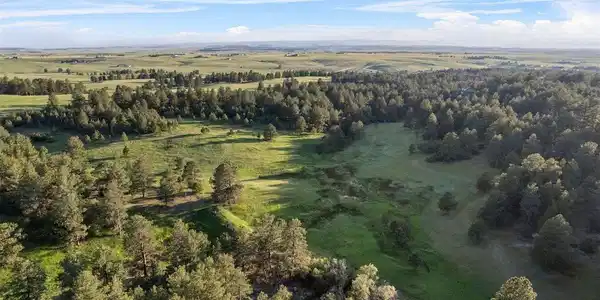 Image 3: Trails wind through rolling terrain, open meadows, and wooded ravines, uniting into a breathtaking landscape as inviting as it is beautiful.