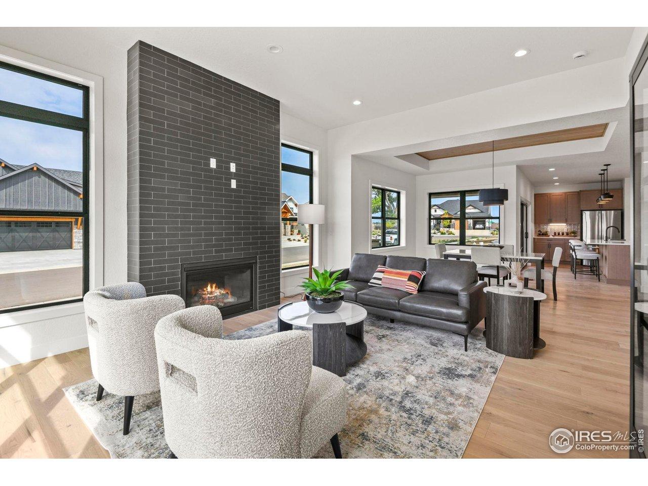 Image 4: Sophisticated living room anchored by a premium fireplace insert and a dramatic ceiling to floor mantel. Image 4: Sophisticated living room anchored by a premium fireplace insert and a dramatic ceiling to floor mantel.