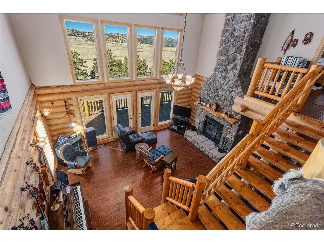 Image 1: The big views are open to the loft area upstairs. The living room is surrounded with natural light and warmth. Image 1: The big views are open to the loft area upstairs. The living room is surrounded with natural light and warmth.