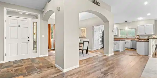 Image 4: The contemporary arches create an integrated flow while identifying separate spaces. Entry and Kitchen have slate tile floors. LVP compliments the tile. Image 4: The contemporary arches create an integrated flow while identifying separate spaces. Entry and Kitchen have slate tile floors. LVP compliments the tile.