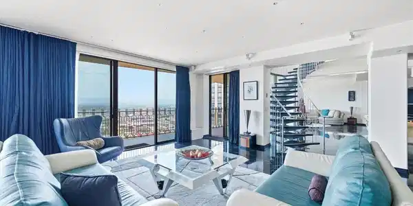 Image 2: Expansive great room with panoramic Downtown Denver and Rocky Mountain views.