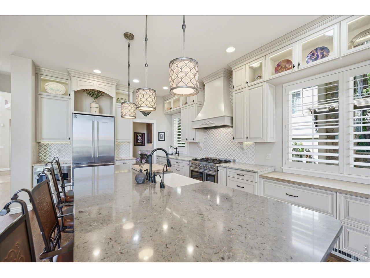 Image 4: The huge quartz island with bar seating serves as the heart of the home Image 4: The huge quartz island with bar seating serves as the heart of the home