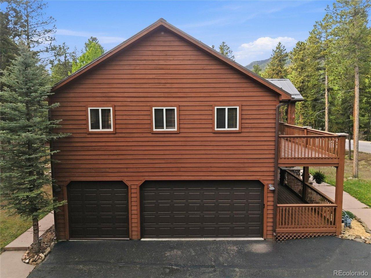 Image 4: 3-Car attached garage with paved driveway, front porch deck and upper deck. Image 4: 3-Car attached garage with paved driveway, front porch deck and upper deck.