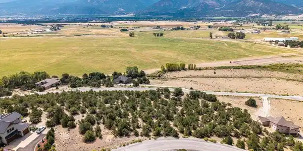 Image 4: Aerial views to the South with the Saguache Range in the back drop and green ranch land.