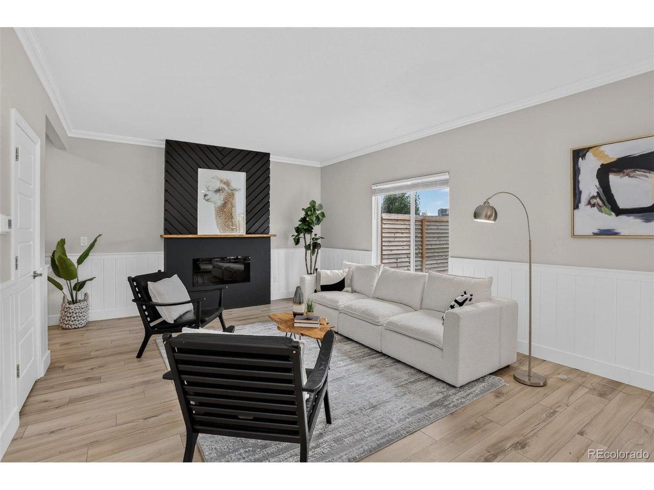 Image 2: Family room, fireplace, wainscotting, new flooring, new paint, open floor plan Image 2: Family room, fireplace, wainscotting, new flooring, new paint, open floor plan