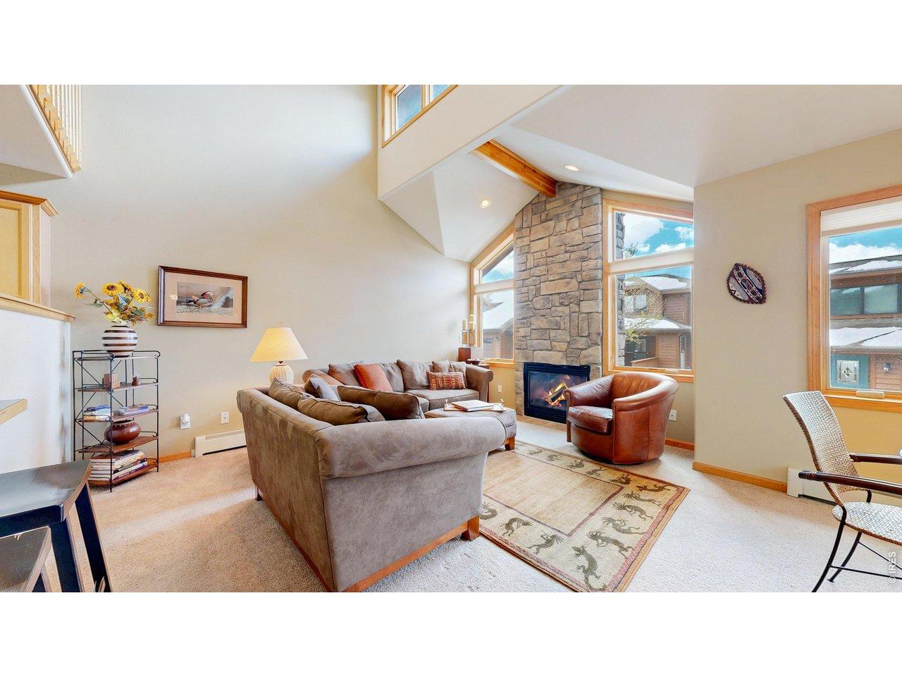 Image 3: A Beautiful Open Floor plan with volume ceilings, Stone gas fireplace and expansive windows. Look at all the natural light flooding this space. Image 3: A Beautiful Open Floor plan with volume ceilings, Stone gas fireplace and expansive windows. Look at all the natural light flooding this space.