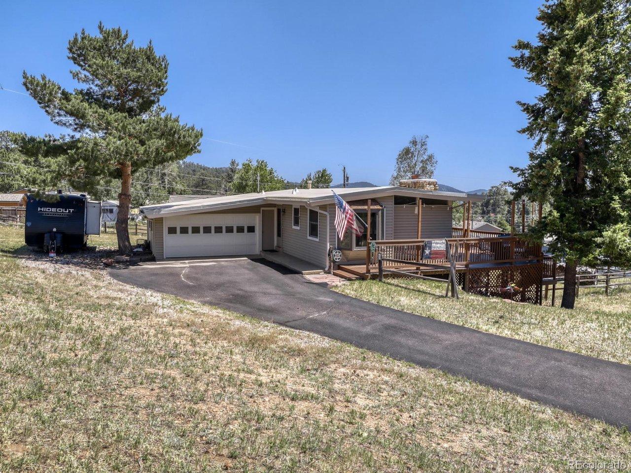Image 1: Exterior front with paved driveway. Image 1: Exterior front with paved driveway.