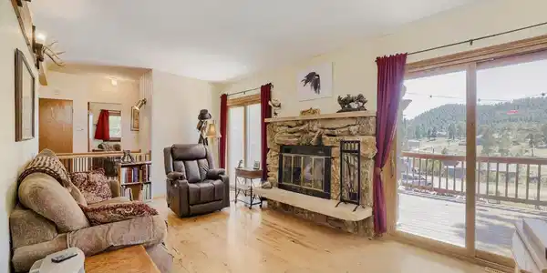 Image 4: Living room fireplace flanked by two NEW Anderson sliding doors. Image 4: Living room fireplace flanked by two NEW Anderson sliding doors.