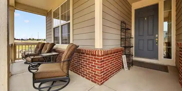 Image 3: Relax with your morning coffee or greet guests from the inviting covered front porch overlooking the beautifully landscaped corner lot. Image 3: Relax with your morning coffee or greet guests from the inviting covered front porch overlooking the beautifully landscaped corner lot.
