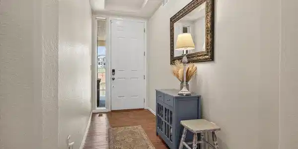 Image 4: Step inside to a welcoming foyer featuring engineered hardwood flooring and an open floor plan that immediately feels warm and inviting. Image 4: Step inside to a welcoming foyer featuring engineered hardwood flooring and an open floor plan that immediately feels warm and inviting.
