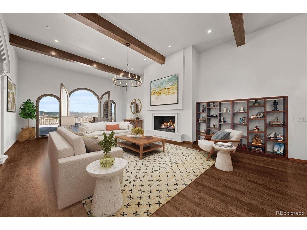 Image 4: The great room is anchored by a modern cast concrete fireplace, and just look at those views. Virtually staged.