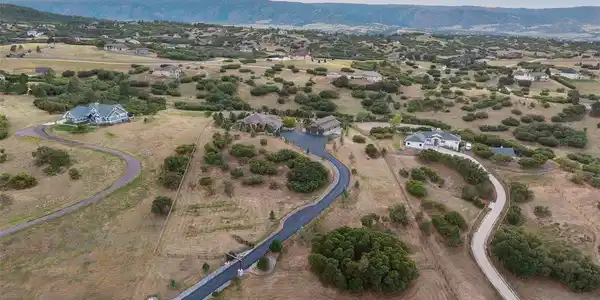 Image 2: Set on 5 private acres on one of Keene Ranch's quietest streets, the home is tucked into the hillside for privacy and sweeping views of the mountains and Dawson Butte.