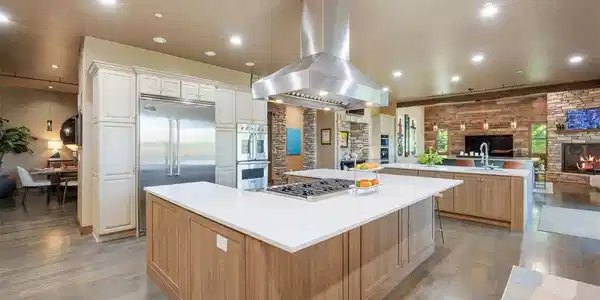 Image 3: The remarkable kitchen is one of the largest in Keene Ranch! Three huge islands, 6 ovens, plus a built-in wood stone pizza oven.