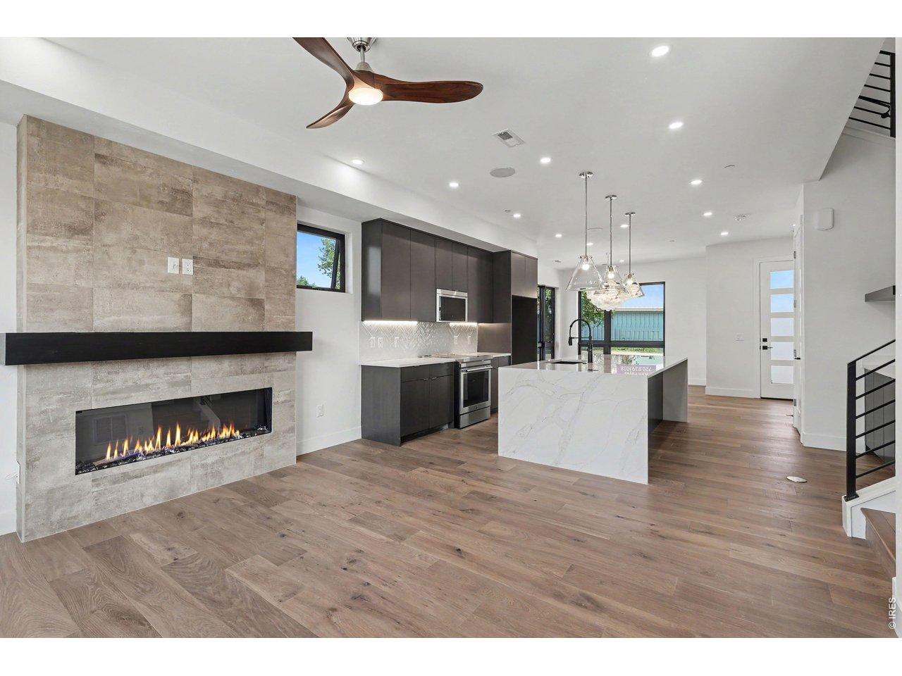 Image 3: The open-concept floor plan seamlessly connects the kitchen, dining, and living spaces, creating an inviting setting for everything from intimate dinners to lively gatherings with family and friends.