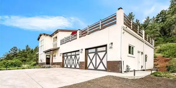 Image 2: Daytime view of the front of the home with 3-car heated garage. Image 2: Daytime view of the front of the home with 3-car heated garage.