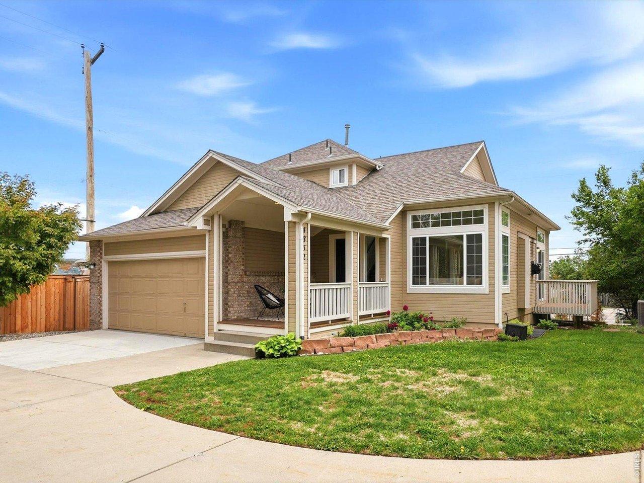 Image 4: Beautiful landscaping, mature plantings, and a spacious front lawn create an inviting approach to the home.