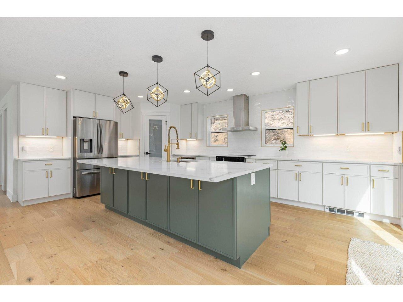 Image 4: A beautiful and well appointed kitchen with ample storage and a pantry.