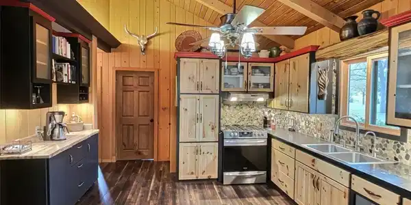 Image 3: The kitchen is a chef's delight, with leathered granite countertops, gas stove and soft-close drawers throughout Image 3: The kitchen is a chef's delight, with leathered granite countertops, gas stove and soft-close drawers throughout