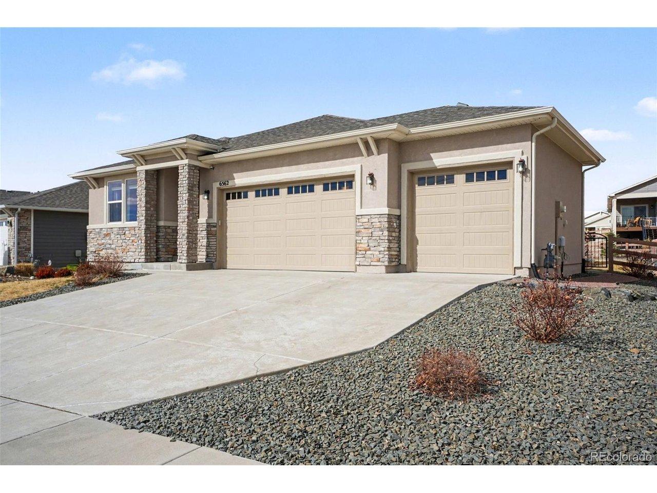 Image 3: 3-car garage with a large driveway, offering ample parking and easy access. The stucco exterior and landscaped yard complement the garage, creating a polished and functional curb appeal. Image 3: 3-car garage with a large driveway, offering ample parking and easy access. The stucco exterior and landscaped yard complement the garage, creating a polished and functional curb appeal.