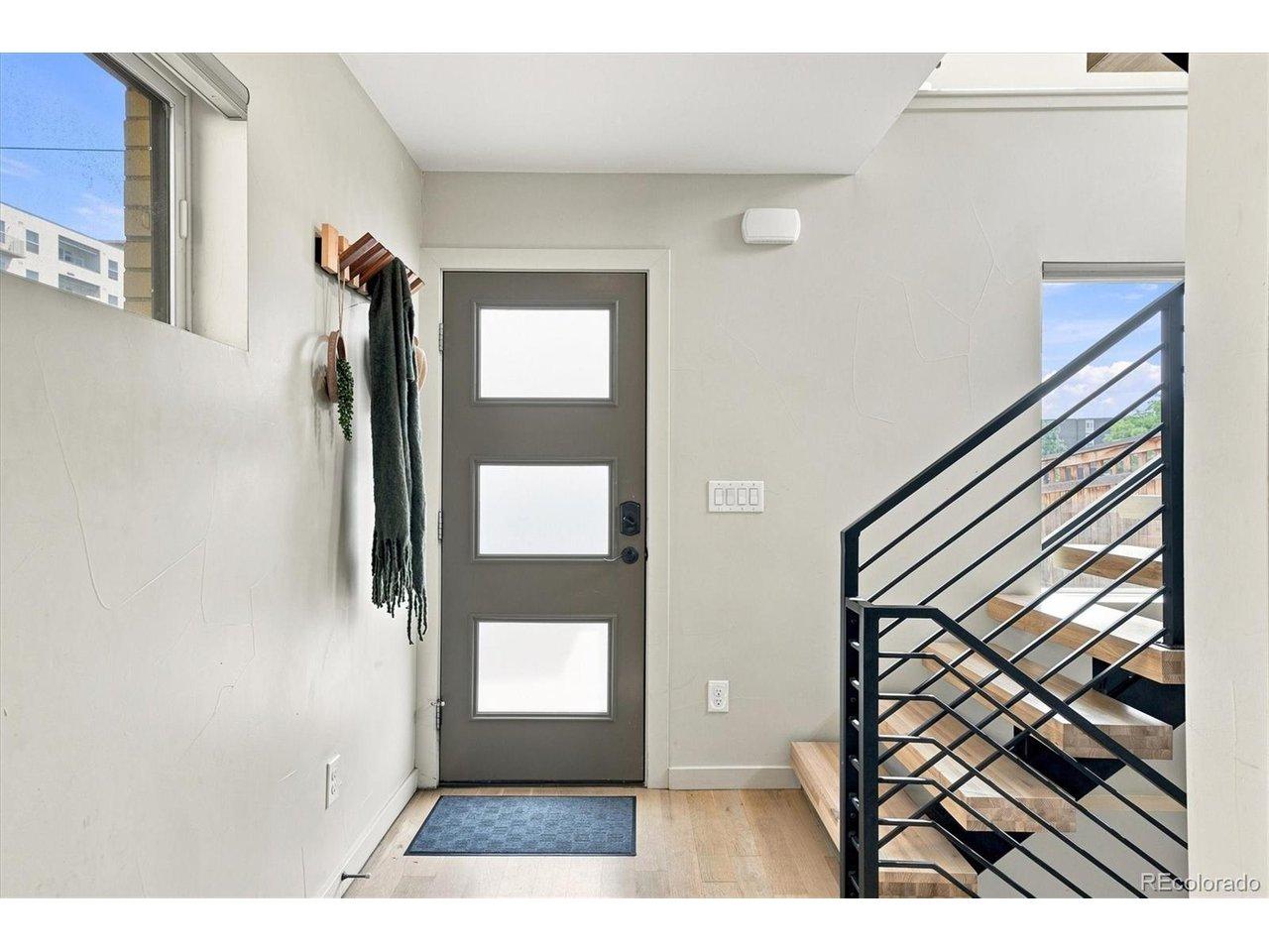 Image 3: Step inside to a bright entry and the home's modern open staircase connecting each level. Image 3: Step inside to a bright entry and the home's modern open staircase connecting each level.