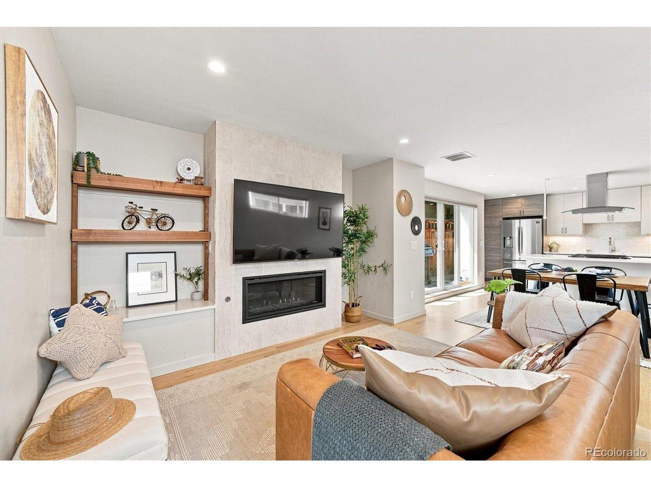 Image 4: The open living room is filled with natural light and flows seamlessly into the kitchen and dining spaces. Image 4: The open living room is filled with natural light and flows seamlessly into the kitchen and dining spaces.