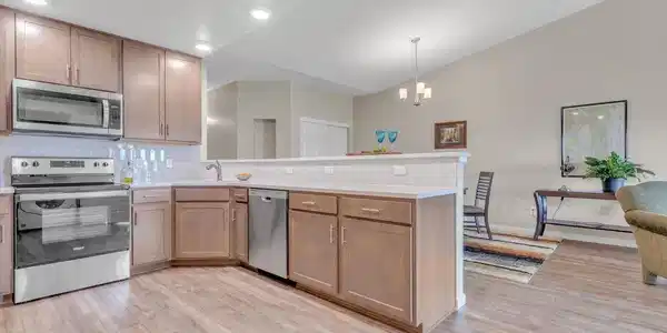 Image 3: Sleek modern kitchen featuring Quartz countertops, 42" Birch cabinets and LVP floors