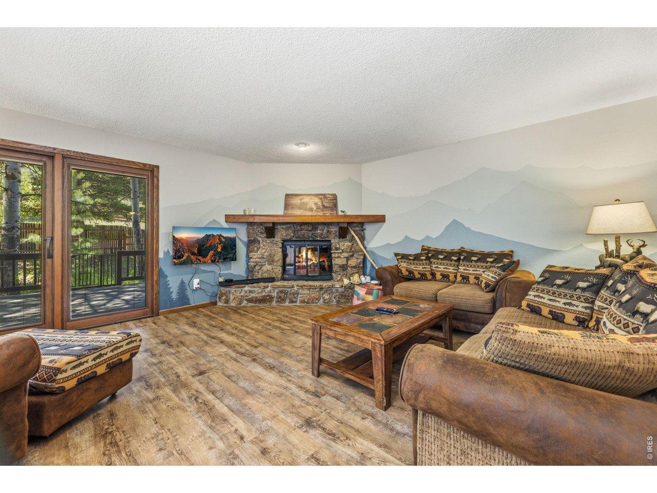 Image 4: The stone fireplace is the focal point of the living room