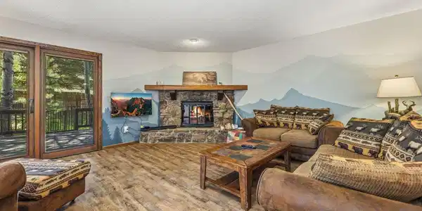 Image 4: The stone fireplace is the focal point of the living room