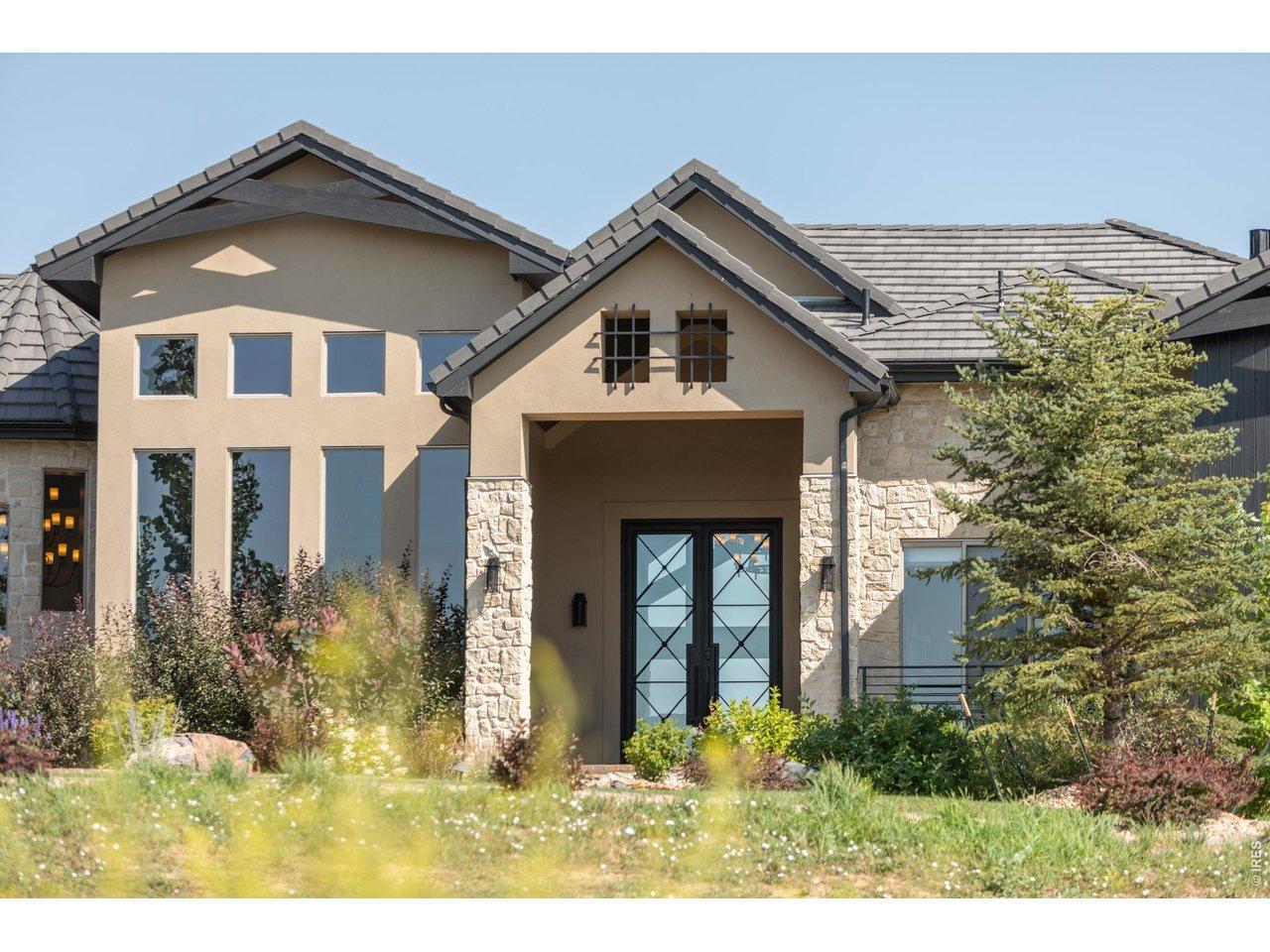 Image 2: A dramatic 10-foot iron front door and handcrafted stone fa ade create an unforgettable first impression. Image 2: A dramatic 10-foot iron front door and handcrafted stone fa ade create an unforgettable first impression.